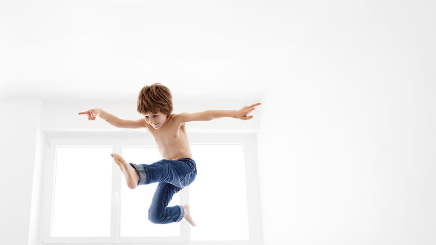 Kid jumping on the bed